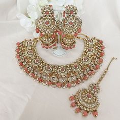 Beautifully flexible Antique Gold intricate necklace set scattered with dazzling clear rhinestone crystals and colourful bead detailing Comes with matching long jhumka earrings (approx 3 inch length x 1.5 inch width) and matching tikka ( pendant part 2 inch length x 1 inch width)  Ready to ship as seen with gift box! Reception Jewellery, Long Jhumka Earrings, Intricate Necklace, Jewelry Hacks, Indian Bridal Jewelry Sets, Jewelry Set Design, Bridal Necklace Set, Indian Jewelry Sets, Bangles Jewelry Designs