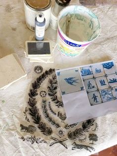 the table is covered with various items for making decorative wall hangings and paper towels