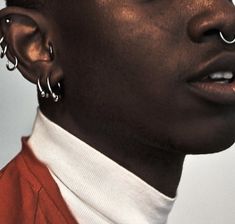 a man with piercings on his ears and nose