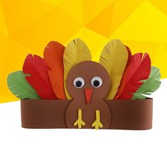 a paper turkey sitting in a flower pot with feathers on it's head and eyes