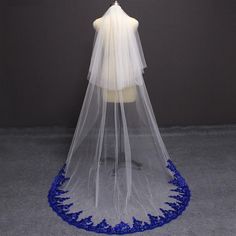 a white veil with blue trim on top of a mannequin's head