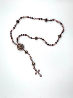 This handmade rosary is prefect for prayer, meditation, or hanging on your review mirror. The elastic string allows it to be worn as a bracelet if you double loop it! Spiritual Beaded Rosary As Gift, Beaded Rosary Bracelet For Meditation, Meditation Beaded Rosary Bracelet, Spiritual Beaded Rosary For Jewelry Making, Hand-strung Adjustable Spiritual Rosary Bracelet, Adjustable Spiritual Rosary Bracelet With 108 Beads, Adjustable Spiritual Rosary With Spacer Beads, Beaded Cross Rosary For Meditation, Meditation Cross-shaped Beaded Rosary