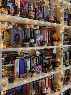 a bookshelf filled with lots of books covered in christmas lights and decorations on top of it