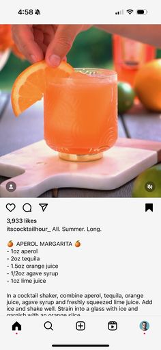 someone is squeezing an orange into a glass on a cutting board with the recipe below