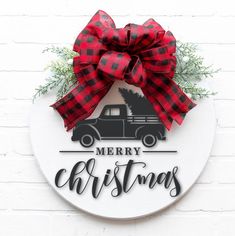 a merry christmas sign with a red bow on it