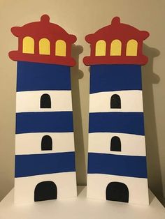 two blue and white lighthouses are sitting on a table