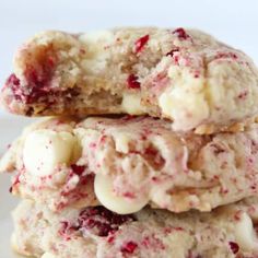 three cookies stacked on top of each other with white chocolate chips and cranberries