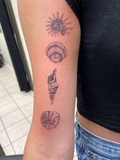 a woman with a tattoo on her arm showing different things in the shape of balloons