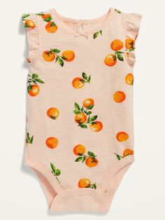 a pink bodysuit with oranges on it and green leaves all over the chest