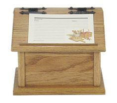 a wooden desk with a note pad and pen on it's stand, in front of a white background