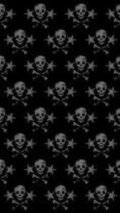 a black and white photo with skulls and crossbones in the middle on a dark background