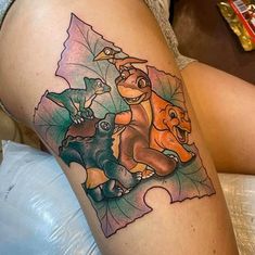 a woman's thigh with an animal themed tattoo on her left leg and the word disney written in it