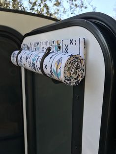 a roll of toilet paper sitting on top of a black and white door