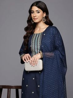 Grab this beautiful 3-piece set. The set comes with ethnic motif print & embroidered straight shape kurta has round neck, 3/4th flared sleeves & calf length teamed with solid trouser pant with slip on closure & semi elasticated waistband and a dupatta. Color - Navy Blue Kurta Fabric-Silk Blend Pant Fabric-Silk Blend Dupatta Fabric - Silk Chiffon Neck-Round Neck Sleeves-3/4th Sleeves Work - Ethnic Motif Print & Embroidery Detailing Washing Instructions-Dry Clean DISCLAIMER - The color of the product may be differ due to screen settings of device. A misprint here and a color drop slip there is the beauty of printing which is not treated as a defect. Elegant Kurta With Printed Motifs For Navratri, Elegant Navratri Kurta With Printed Motifs, Transitional Blue Georgette Kurta, Blue Georgette Sharara With Printed Motifs, Elegant Sets With Printed Motifs For Navratri, Elegant Blue Salwar Kameez With Printed Motifs, Blue Georgette Sets For Transitional Season, Transitional Blue Georgette Sets, Elegant Sharara With Printed Motifs For Diwali