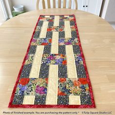 the table runner is made from old quilts and has been placed on top of a dining room table