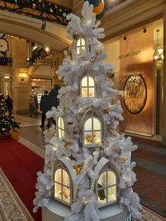 a white christmas tree in the lobby of a hotel