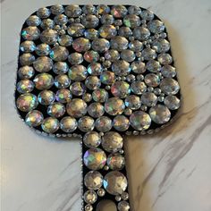 the back of a black case with lots of crystal stones on it