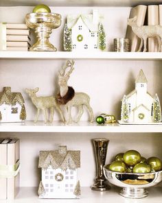 christmas decorations and ornaments on shelves in a room