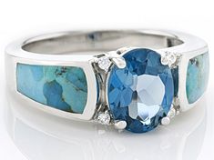 2.36ct Oval London Blue Topaz with 10x5x3mm Inlay Composite Turquoise and 0.34ctw Round White Zircon Rhodium Over Sterling Silver Ring. Measures Approximately 0.88"L x 0.35"W. Not sizeable. This product contains composite turquoise. This means separate pieces of turquoise were bound together. Accent stones primarily zircon. Fine Jewelry Turquoise Ring With Accent Stones, Oval Cabochon Gemstones With Accent Stones For Anniversary, Blue Aquamarine Three Stone Jewelry, Anniversary Oval Cabochon Gemstones With Accent Stones, Oval Multi-stone Blue Topaz Ring, Oval Aquamarine Multi-stone Rings, Oval Multi-stone Aquamarine Ring, Turquoise Topaz Ring With Center Stone, Fine Jewelry Turquoise Ring With Accent Stones For Anniversary