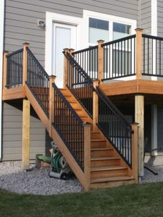 an outside view of a house with stairs and railings