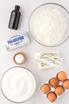 eggs, milk, flour and other ingredients on a white counter top for making pancakes