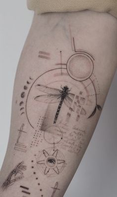 a woman's thigh with an abstract tattoo design on the side of her leg