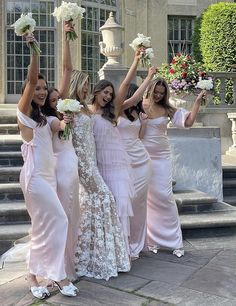 the bridesmaids are all wearing pink dresses and holding bouquets in their hands