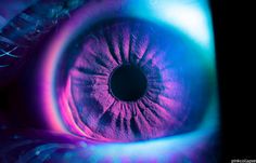 the iris of an eye is glowing brightly