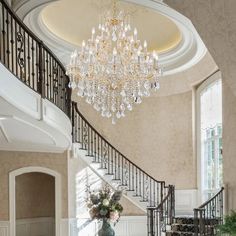 an elegant foyer with chandelier and marble flooring is pictured in this image