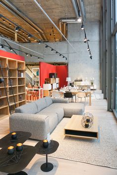 a living room filled with furniture and lots of bookshelves on top of it