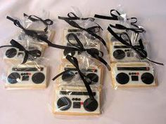 some cookies are wrapped in clear plastic and have black ribbon around the top one is decorated with an old school radio