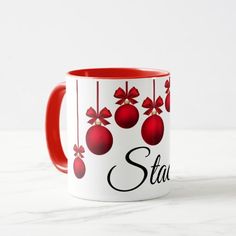 a red and white coffee mug with christmas ornaments on it