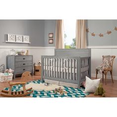 a baby's room with furniture and decor in blue, gray and white colors