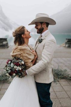 a bride and groom standing next to each other