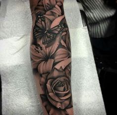 a black and white rose with butterflies on it's leg, done by person