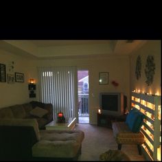 a living room filled with furniture next to a sliding glass door