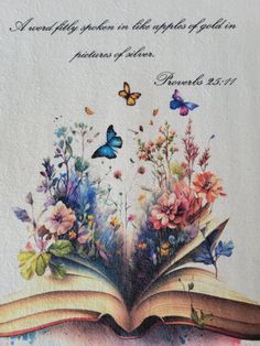 an open book with flowers and butterflies on it