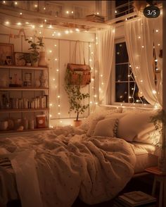 an unmade bed in a bedroom with lights on the wall and curtains over it