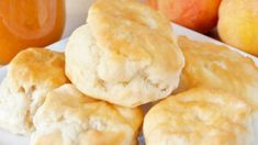 some biscuits are sitting on a plate next to apples