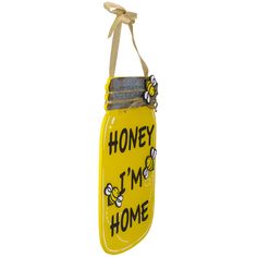 a yellow mason jar hanging from a string with the words honey i'm home on it