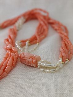 This mid-century multi-strand necklace is a beautiful combination of natural coral and Kashi (river) pearls. The five-strand necklace contrasts the pink coral with luminescent river pearls and 14k yellow gold beads. The long 32-inch length easily slips on for a seamless design. A large, carved coral bead with an Asian motif is the finishing touch of this special necklace. * 32-inch length * 5 strands * Coral and Kashi (river) pearl beads * 14k gold accent beads Thank you for visiting Second Chap Elegant Multi-strand Red Coral Jewelry, Elegant Hand-strung Coral Necklaces, Elegant Hand-strung Coral Necklace, Elegant Coral Hand-strung Necklaces, Multi-strand Red Coral Beaded Necklaces, Coral Multi-strand Beaded Necklaces, Coral Multi-strand Beaded Necklace, Coral Red Multi-strand Beaded Necklaces, Elegant Double Strand Coral Necklace