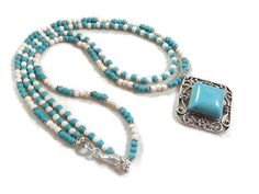 This necklace created by Jewelry By CARMAL is made a turquoise (howlite) and silver pendant, turquoise and white howlite gemstones, silver plated:  daisy spacers, lobster claw clasp and findings.  The short necklace measures 18 inches and the longer necklace measures 20 inches. View more beaded necklaces:  http://www.etsy.com/shop/jewelrybycarmal?section_id=7999556 WE OFFER FREE STANDARD SHIPPING WITHIN THE UNITED STATES. All of our jewelry is unique and custom designed. We would love to assist White Turquoise Gemstone Beads Necklace For Gifts, White Turquoise Necklace With Gemstone Beads For Gifts, White Turquoise Necklace With Gemstone Beads As Gift, White Southwestern Turquoise Necklace Gift, Southwestern White Turquoise Necklace Gift, Southwestern Style White Turquoise Necklace As Gift, Southwestern Style White Turquoise Necklace Gift, Beaded Turquoise Howlite Necklace As Gift, Beaded Howlite Turquoise Necklace Gift