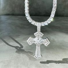 Introducing our stunning Silver Enchanted Cross Necklace! Prepare to turn heads and capture attention with its mesmerizing sparkle and shine. This necklace is truly a showstopper that exudes elegance.The focal point of this necklace is its beautiful cross pendant, meticulously paved with high-quality cubic zirconia crystals. These crystals create a dazzling effect, catching the light from every angle and reflecting it in a mesmerizing display of brilliance. The intricate detailing of the cross a Luxury Handmade German Silver Necklace, Silver Iced Out Cross Pendant Necklace, Diamond White Crystal Cross Pendant Jewelry, Crystal Cross Necklace With Adjustable Chain, White Gold Bling Cross Jewelry, Diamond Cross Necklace Iced Out, White Crystal Cross Necklaces, Elegant Iced Out Cross Pendant Jewelry, Iced Out Diamond White Cross Jewelry