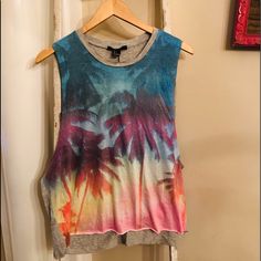 Forever 21 Palm Tree Muscle Tee. Brand New, With Tags! High Neck, Sleeveless. Grey Back, Blue, Pink, Yellow, Orange, Purple On Front. Perfect For Beach, Pool, Vacation, Festival Wear! Follow And Share! Summer Multicolor T-shirt With Rainbow Print, Sleeveless Multicolor Graphic Print T-shirt, Trendy Summer Tank T-shirt, Trendy Summer Crew Neck Tank Top, Trendy Crew Neck Tank Top For Summer, Summer Printed Crew Neck Tank Top, Casual Printed Crop Top Tank Top, Trendy Multicolor Tops With Rainbow Print, Multicolor Sleeveless Graphic Print T-shirt