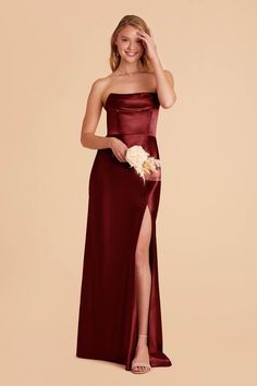 a bridesmaid in a strapless burgundy gown with a slit down the side