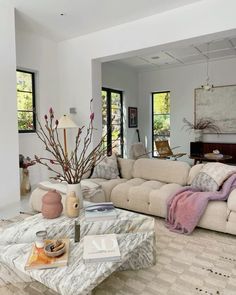 a living room filled with furniture and lots of windows