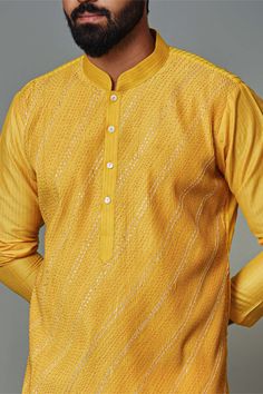 Editor's Note The yellow pintuck kurta with gota pyjama set in cotton silk is a vibrant and stylish ensemble. The yellow color adds a cheerful and sunny vibe to the outfit, while the pintuck detailing on the kurta adds texture and visual interest. Whether for festive occasions or special events, this yellow pintuck kurta set with gota pyjama is sure to make a fashionable statement and leave a lasting impression. Fabric: Cotton silk Color: Yellow Components: Kurta and pants Occasion: Festive Note Yellow Kurta With Chikankari Embroidery For Diwali, Festive Cotton Kurta With Pintucks, Yellow Chikankari Embroidered Straight Kurta, Festive Yellow Lawn Suit With Dabka Details, Unstitched Yellow Kurta With Chikankari Embroidery, Festive Yellow Kurta With Chikankari Embroidery, Yellow Festive Kurta With Chikankari Embroidery, Eid Yellow Kurta With Chikankari Embroidery, Eid Straight Kurta With Pintucks