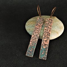 This long copper earrings are a charm Hand cut from copper sheet, then using a ball hammer I gave it that rustic texture, finally applying patina to get that aged boho appearance that gives them so much personality. A simple design that you will love. The ear wires are made by me in copper, they are very light and comfortable to wear. If you are sensitive to metal and prefer sterling silver wires you also have the option to select. All the items of my store are designed and manufactured by me. Beautiful pieces handmade one by one in an artistic way and not mass produced. Unique pieces made with a lot of detail and love. Due to this there might be slight differences in each piece. 💯 I ensure that the pieces always have quality control and that they reach you in perfect condition. Likewise, Hammered Copper Earrings, Patina Copper, Silver Smithing, Copper Gifts, Copper Jewelry Handmade, Rustic Texture, Silver Clay, Hammered Earrings, Copper Sheets