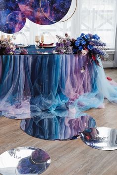 the table is covered with purple and blue fabric