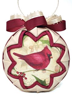 a christmas ornament with a red bird on it